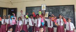 Students displaying colourful handmade lanterns in class
